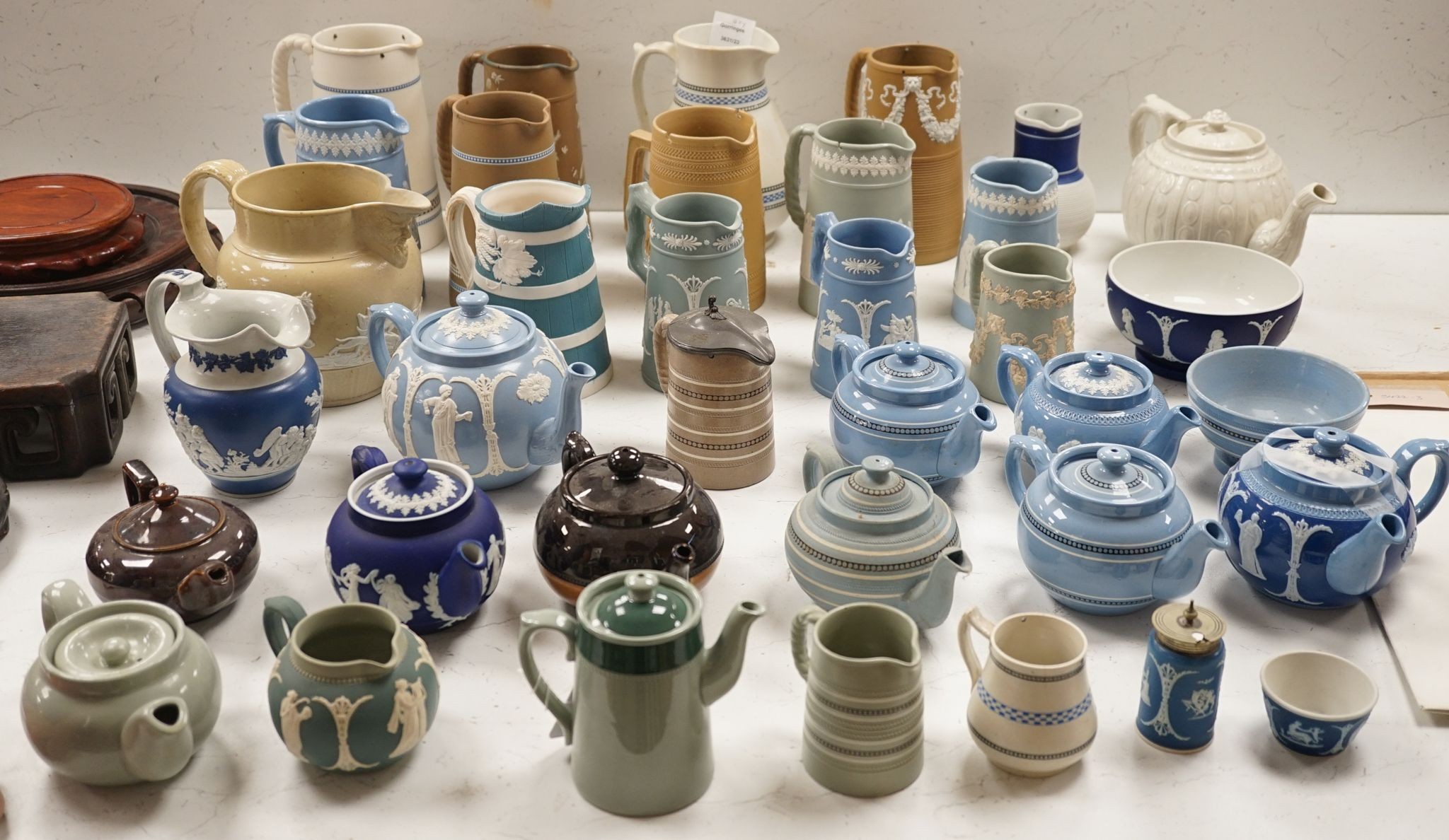 A collection of Dudson stoneware, including jugs, teapots, cream jugs etc, many decorated in low relief